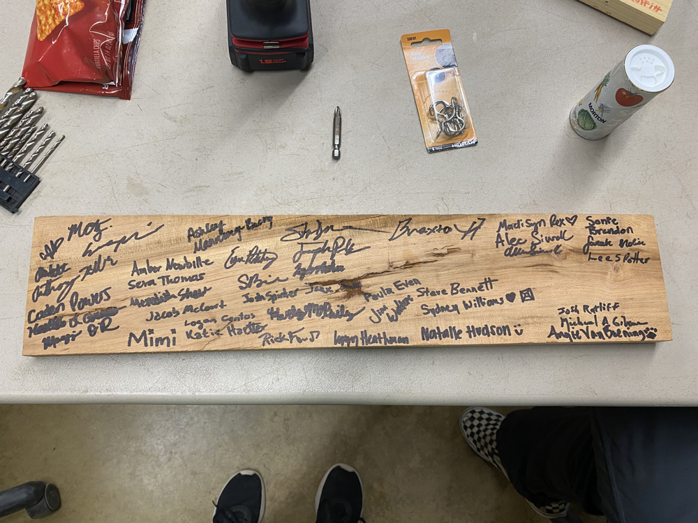 Cedar plank with names of convention participants for display at Coon Creek Nature Center