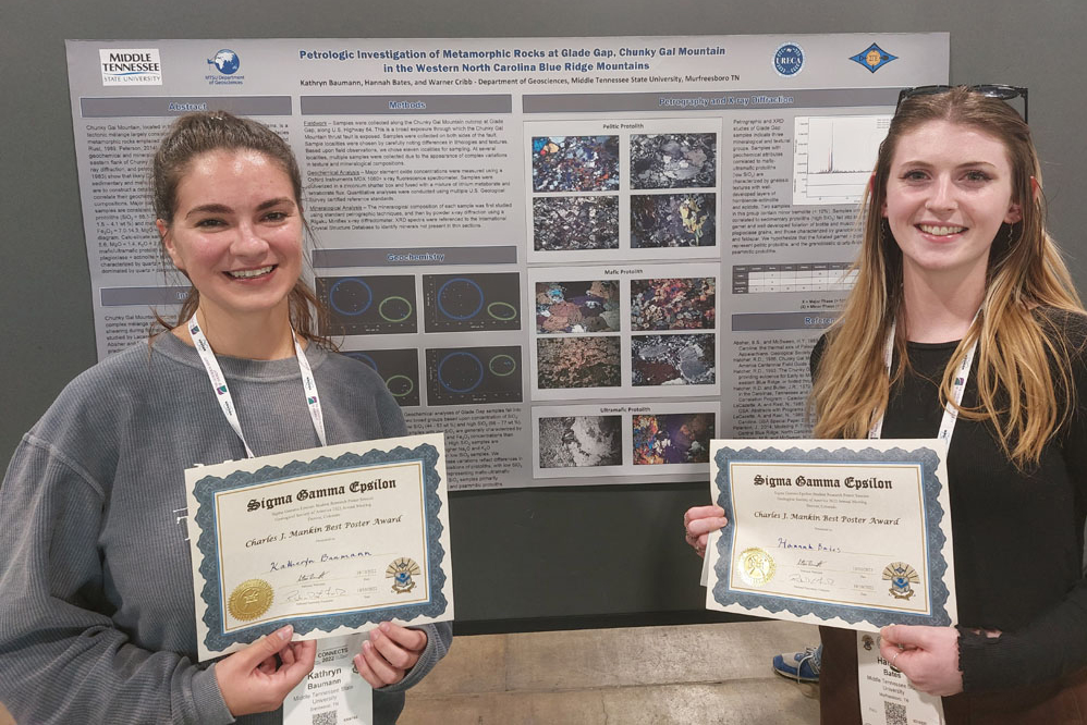 Kathyrn Bauman and Hannah Bates stand by their poster